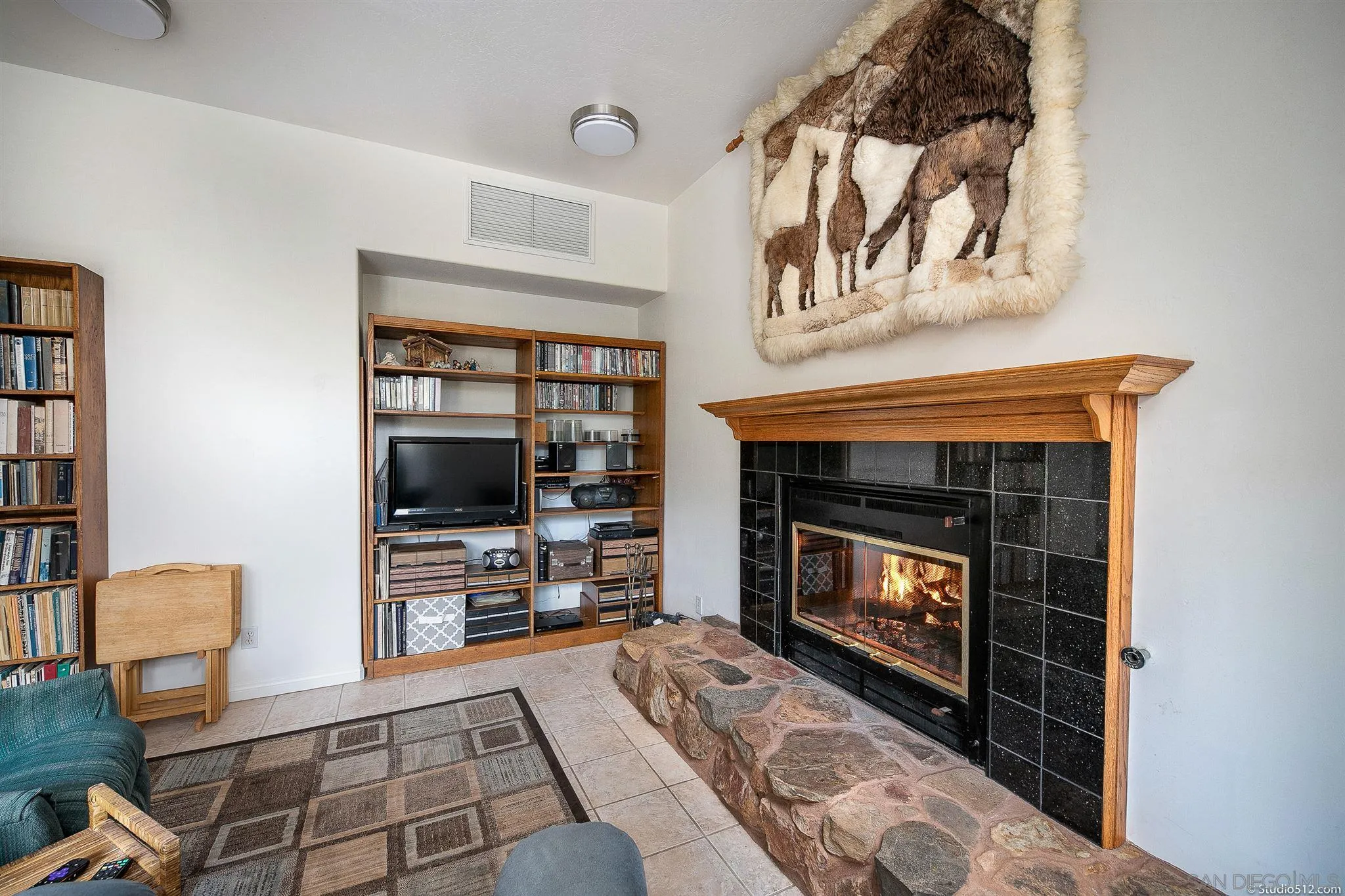 13190 Dermid Road Valley Center, CA 92082 - Photo 8 of 36 a living room with furniture a flat screen tv and a fireplace