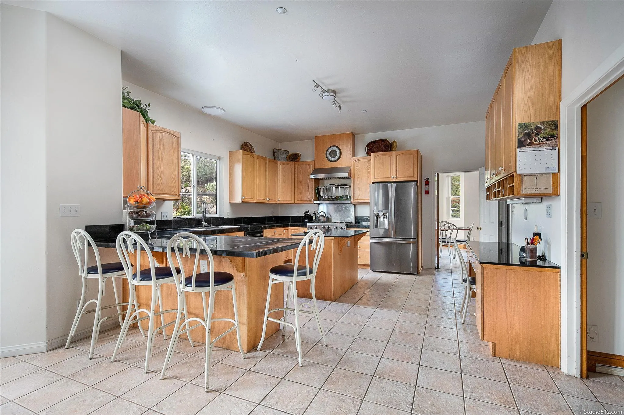 13190 Dermid Road Valley Center, CA 92082 - Photo 9 of 36 a kitchen with stainless steel appliances granite countertop a stove a sink a dining table and chairs