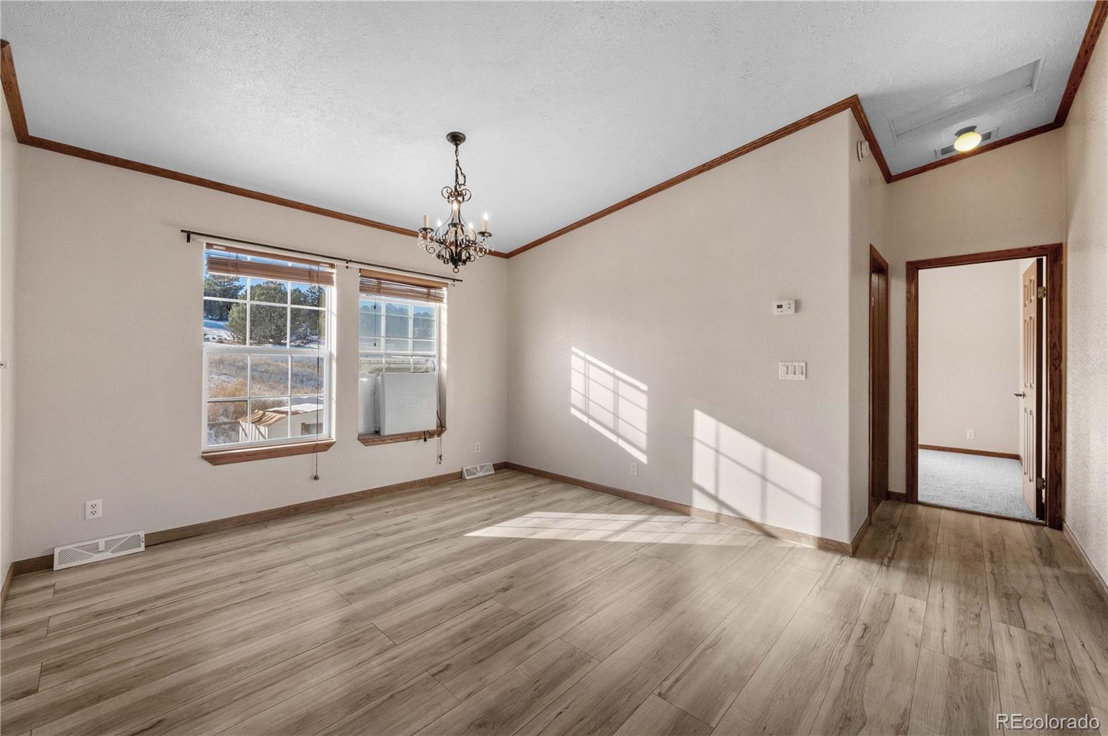 7191 Copper Gulch Road Cotopaxi, CO 81223 - Photo 13 of 50 a view of an empty room with wooden floor and a window