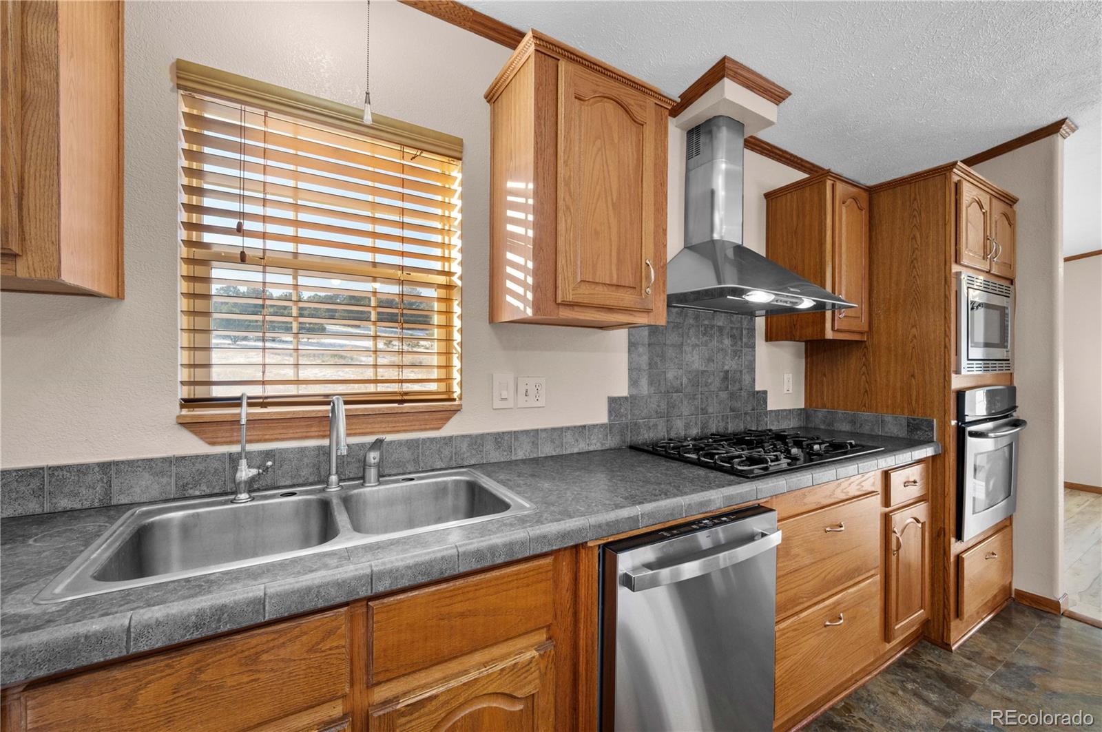 7191 Copper Gulch Road Cotopaxi, CO 81223 - Photo 17 of 50 a kitchen with stainless steel appliances granite countertop a sink stove and cabinets