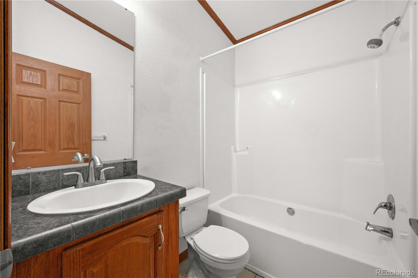 7191 Copper Gulch Road Cotopaxi, CO 81223 - Photo 21 of 50 a bathroom with a granite countertop sink toilet and shower