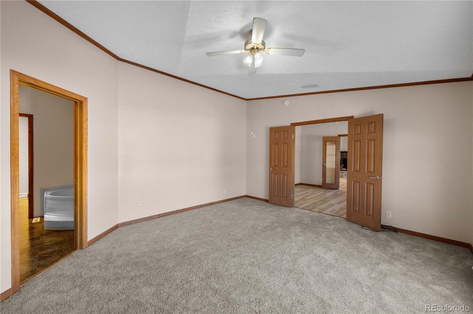 7191 Copper Gulch Road Cotopaxi, CO 81223 - Photo 26 of 50 a view of an empty room with a chandelier fan