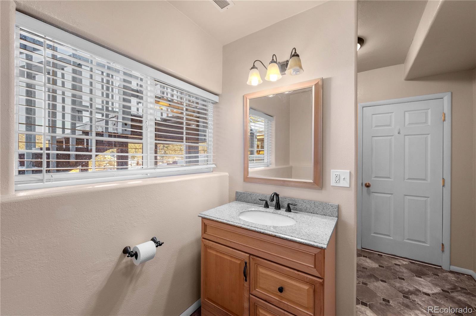 7191 Copper Gulch Road Cotopaxi, CO 81223 - Photo 41 of 50 a bathroom with a sink a vanity and a mirror