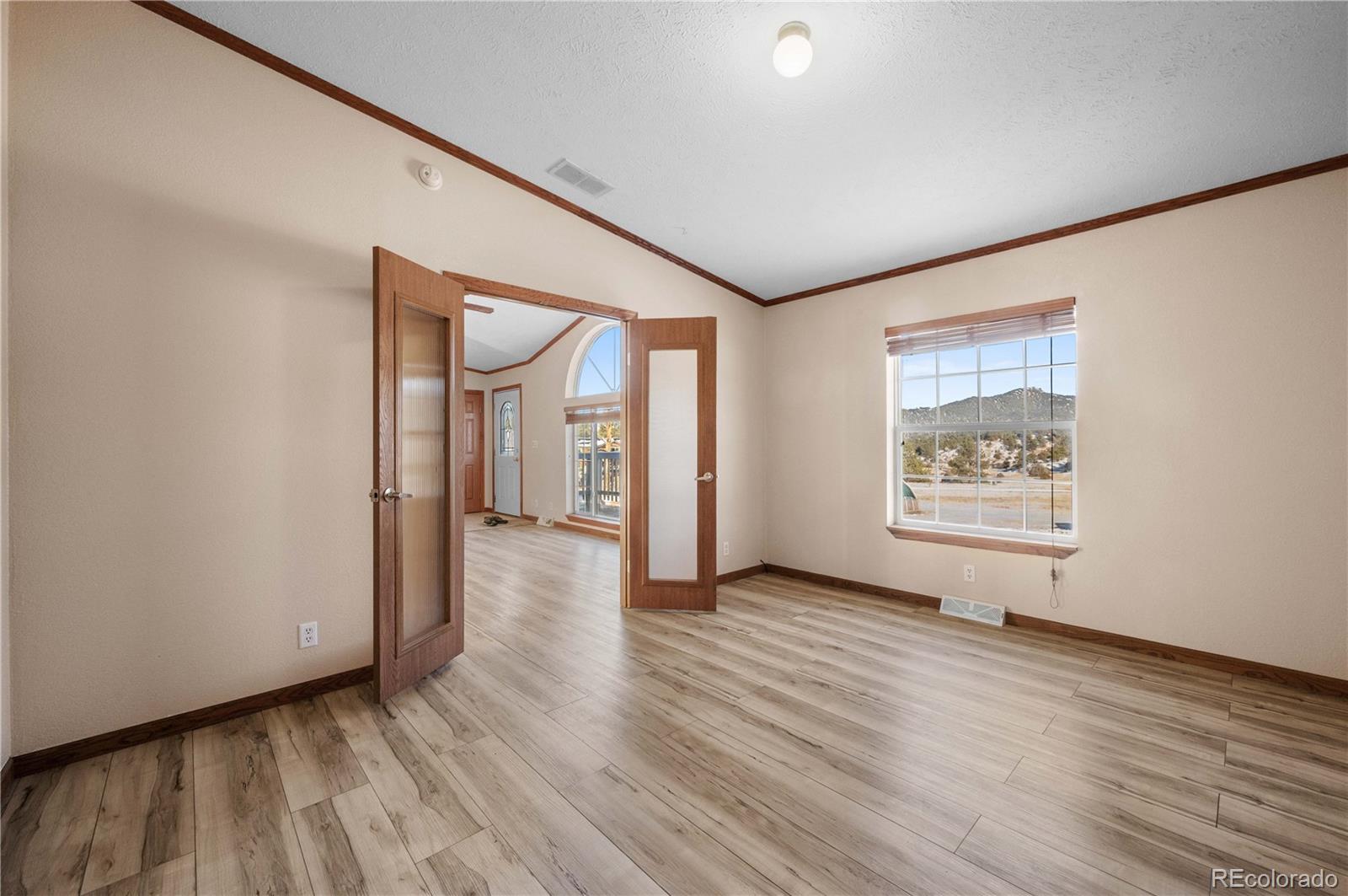 7191 Copper Gulch Road Cotopaxi, CO 81223 - Photo 10 of 50 a view of an empty room with wooden floor and a window