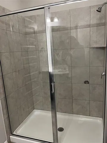 a bathroom with a shower and a sink