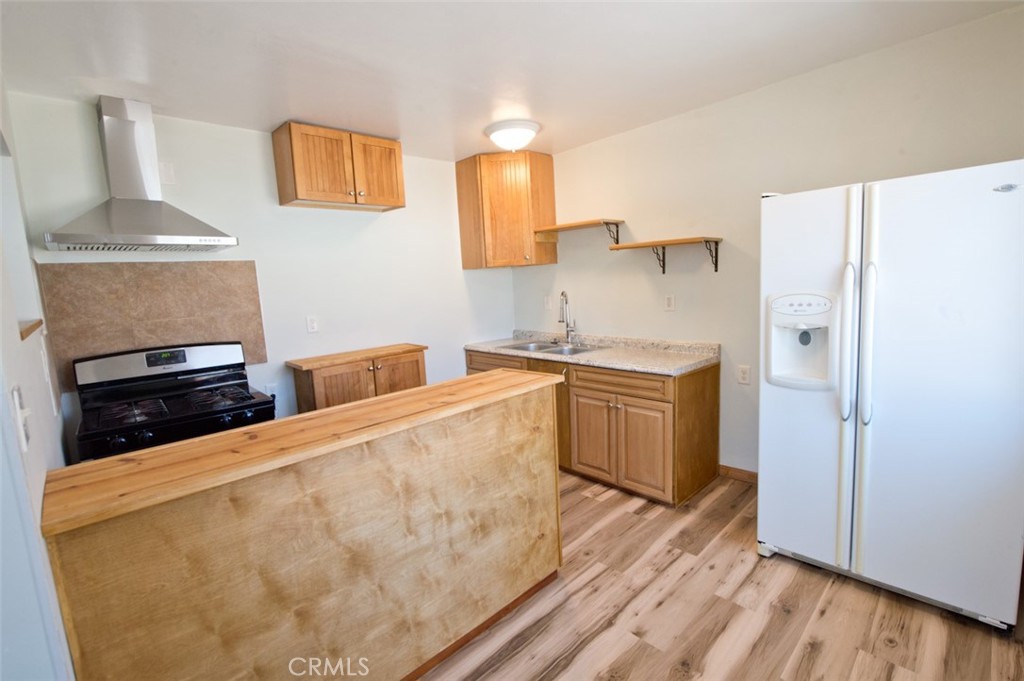 156 West Escalones San Clemente, CA 92672 - Photo 16 of 39 a kitchen with stainless steel appliances a stove a sink and a refrigerator