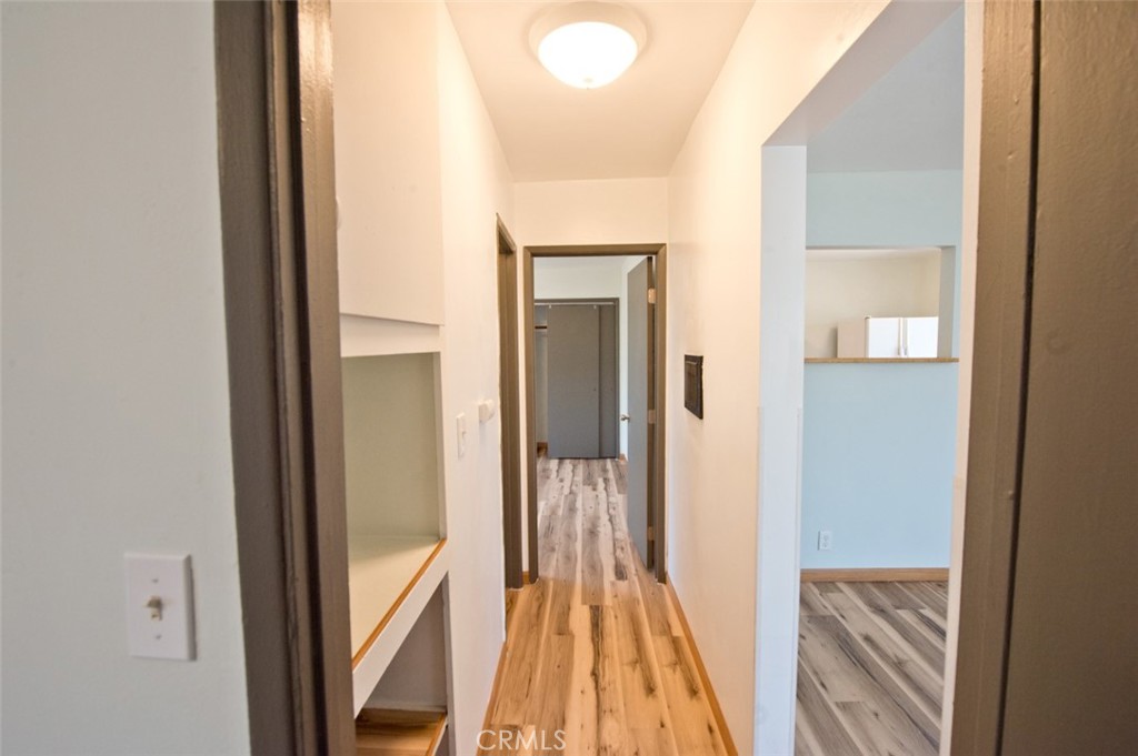 156 West Escalones San Clemente, CA 92672 - Photo 22 of 39 a view of a hallway with wooden floor and a bathroom