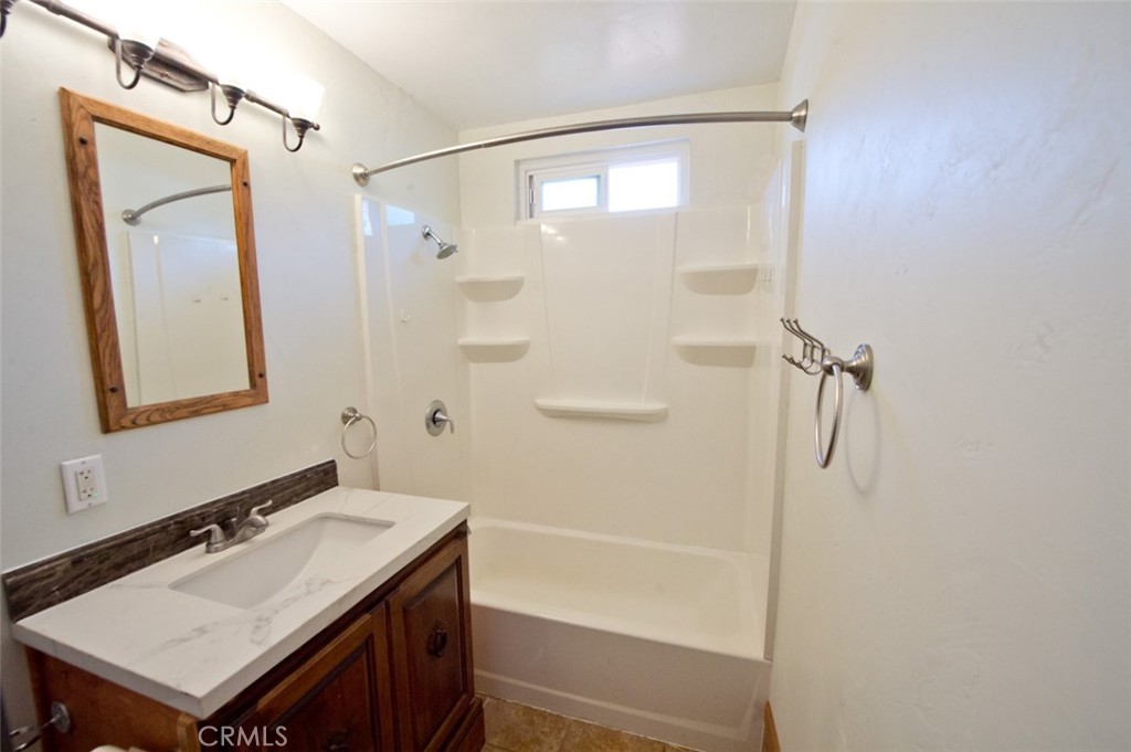 156 West Escalones San Clemente, CA 92672 - Photo 24 of 39 a bathroom with a granite countertop sink mirror toilet and bathtub
