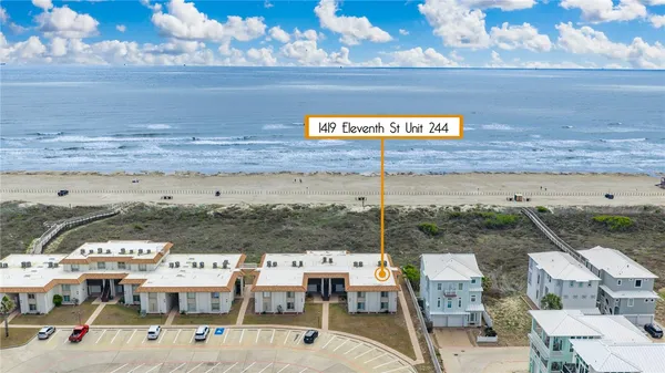 a view of a terrace with lawn chairs