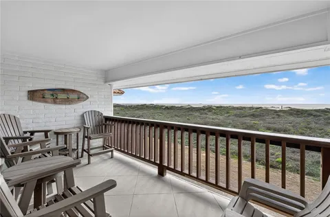 a balcony with a table and chairs