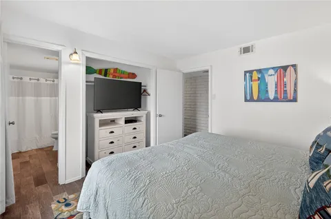 a bedroom with a bed a desk and chair