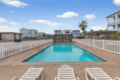 a view of a house with swimming pool and sitting area