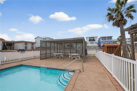 an aerial view of a house with a backyard
