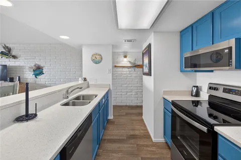 a kitchen that has a sink and a stove