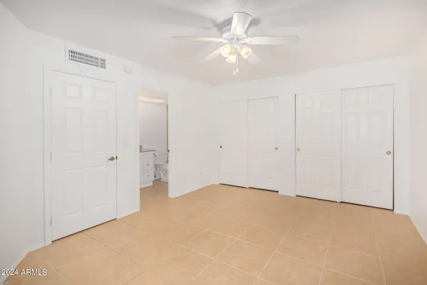 an empty room with a ceiling fan