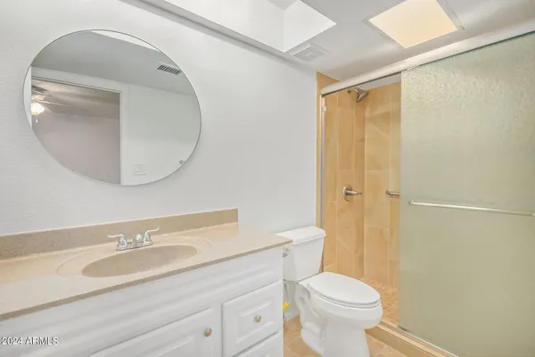 a bathroom with a sink a toilet and a mirror