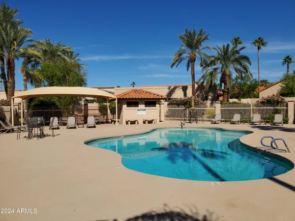 a view of a house with swimming pool and porch