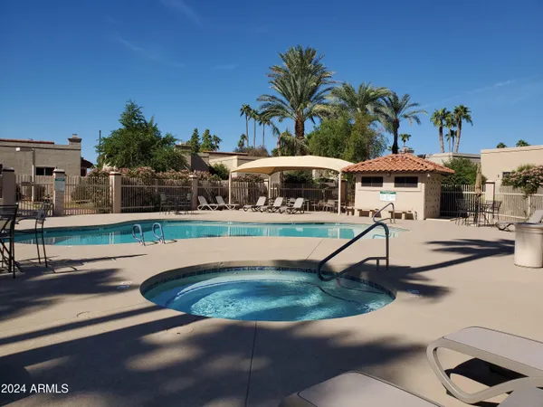 a view of a swimming pool with chairs