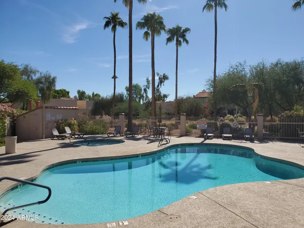 a view of a patio with swimming pool table and chairs