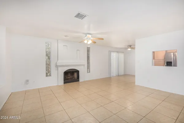 a view of a livingroom with a fireplace and chandelier fan