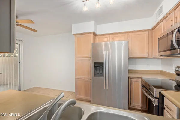 a kitchen with stainless steel appliances a refrigerator and a stove top oven