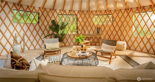 a view of swimming pool with a yard and large trees