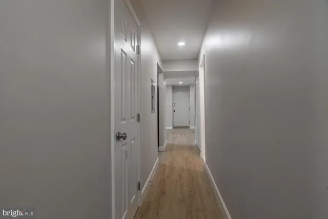 a view of a hallway with wooden floor