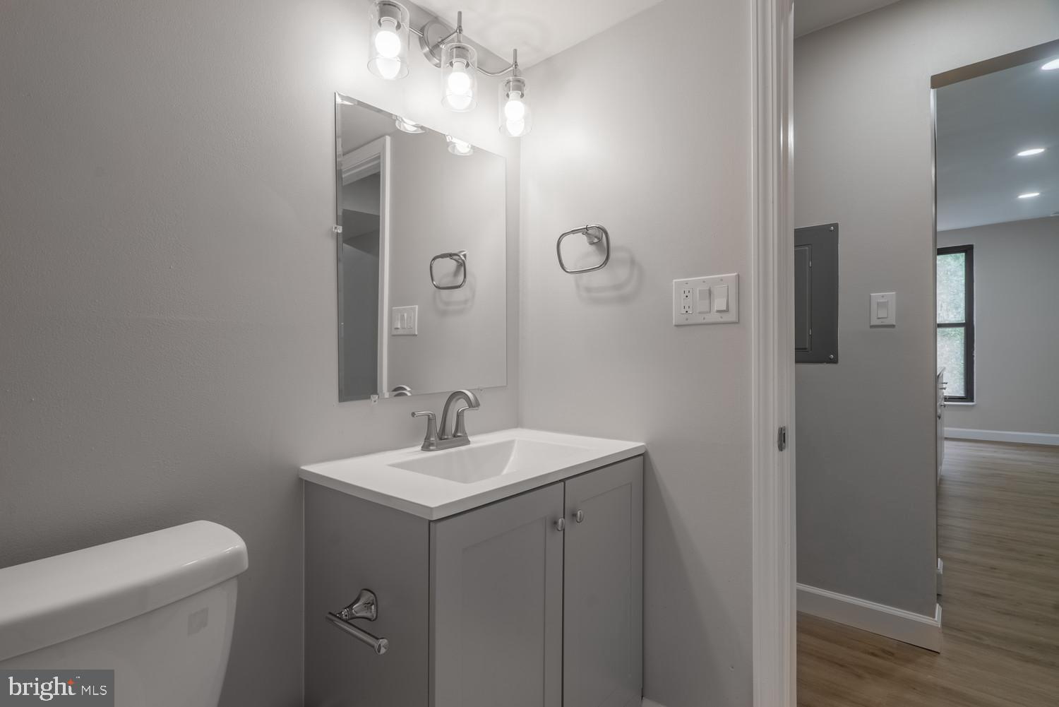 112 Duvall Lane, Unit 304 Gaithersburg, MD 20877 - Photo 16 of 27 a bathroom with a toilet a sink and mirror