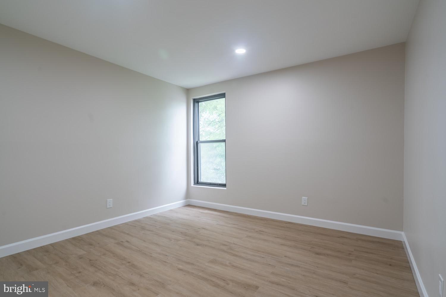 112 Duvall Lane, Unit 304 Gaithersburg, MD 20877 - Photo 20 of 27 wooden floor in an empty room with a window