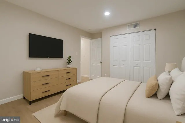 a bedroom with a bed and a flat screen tv in it