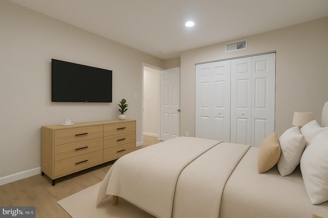 112 Duvall Lane, Unit 304 Gaithersburg, MD 20877 - Photo 24 of 27 a bedroom with a bed and a flat screen tv in it