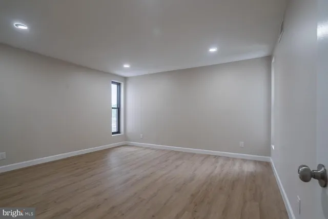 a view of an empty room and wooden floor