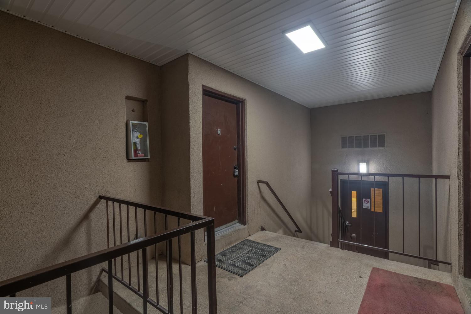112 Duvall Lane, Unit 304 Gaithersburg, MD 20877 - Photo 4 of 27 a view of a hallway with staircase