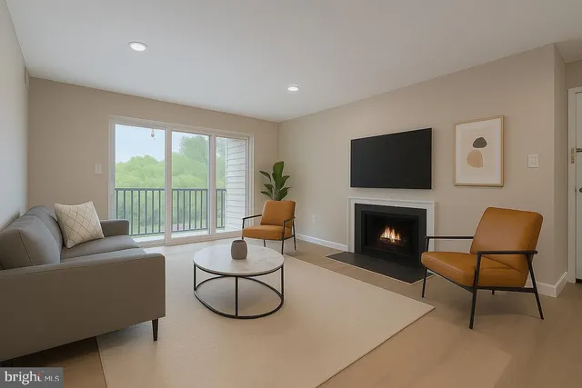 a living room with furniture a flat screen tv and a fireplace
