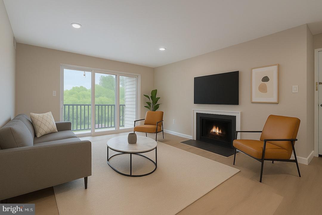 112 Duvall Lane, Unit 304 Gaithersburg, MD 20877 - Photo 8 of 27 a living room with furniture a flat screen tv and a fireplace