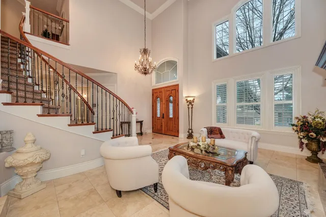 a view of a livingroom with furniture and a chandelier