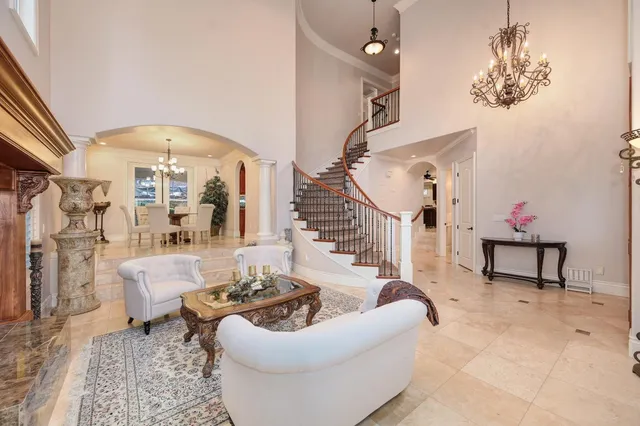 a view of a dining room with furniture and chandelier