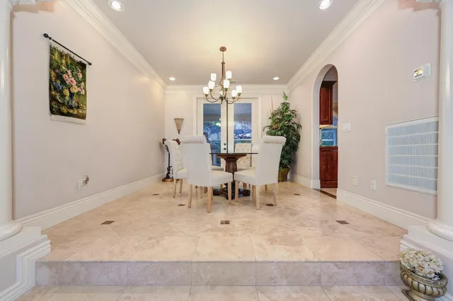 a dining room with furniture and a chandelier