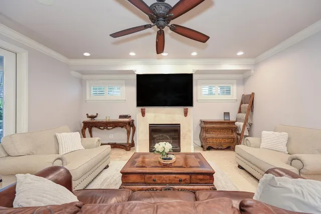 a living room with furniture a ceiling fan and a rug