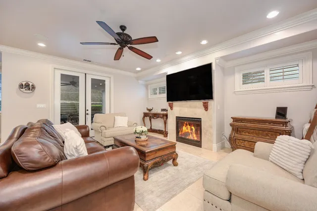 a living room with furniture a fireplace and a flat screen tv