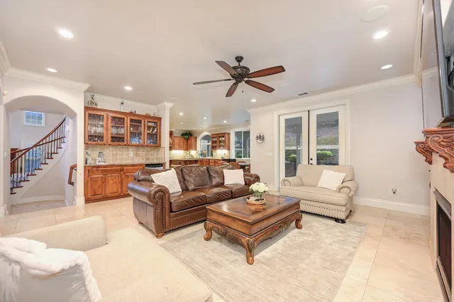 a kitchen with stainless steel appliances granite countertop a stove a sink a dining table and chairs with wooden floor