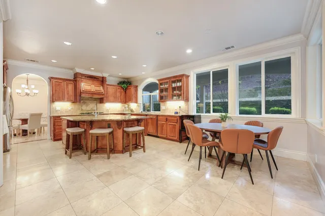 a kitchen with stainless steel appliances granite countertop a stove a sink and a refrigerator