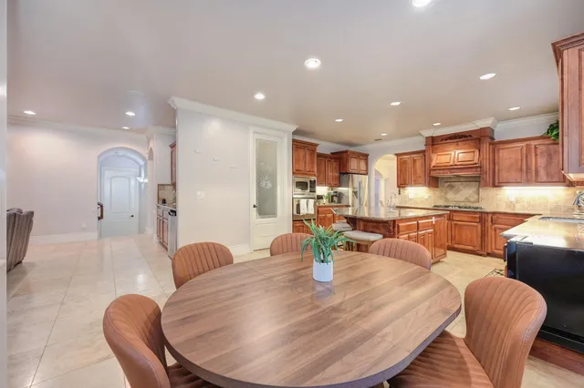 a view of a kitchen with granite countertop a refrigerator oven a sink and dishwasher
