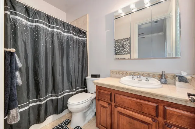 a spacious bathroom with a granite countertop sink and a mirror