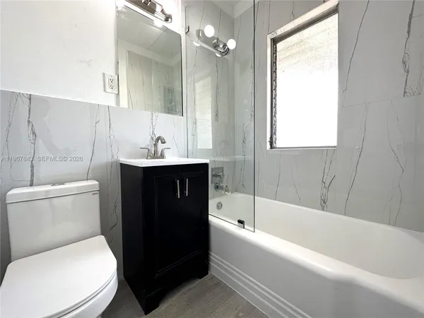 a bathroom with a sink toilet and bathtub