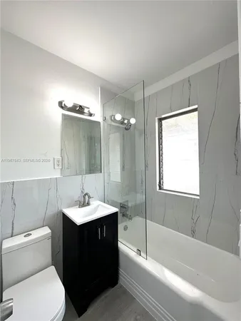 a bathroom with a sink a toilet and bathtub