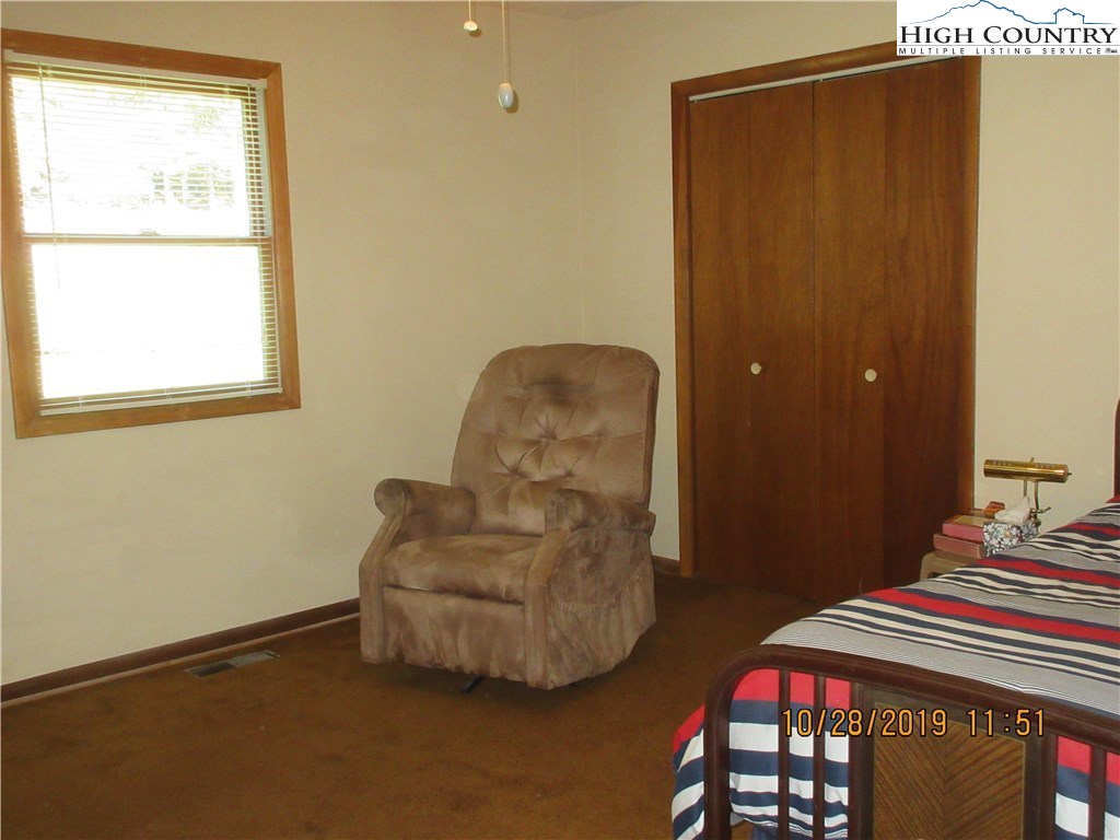 1307 Ben Miller Road Deep Gap, NC 28618 - Photo 12 of 26 a bedroom with a bed and a window