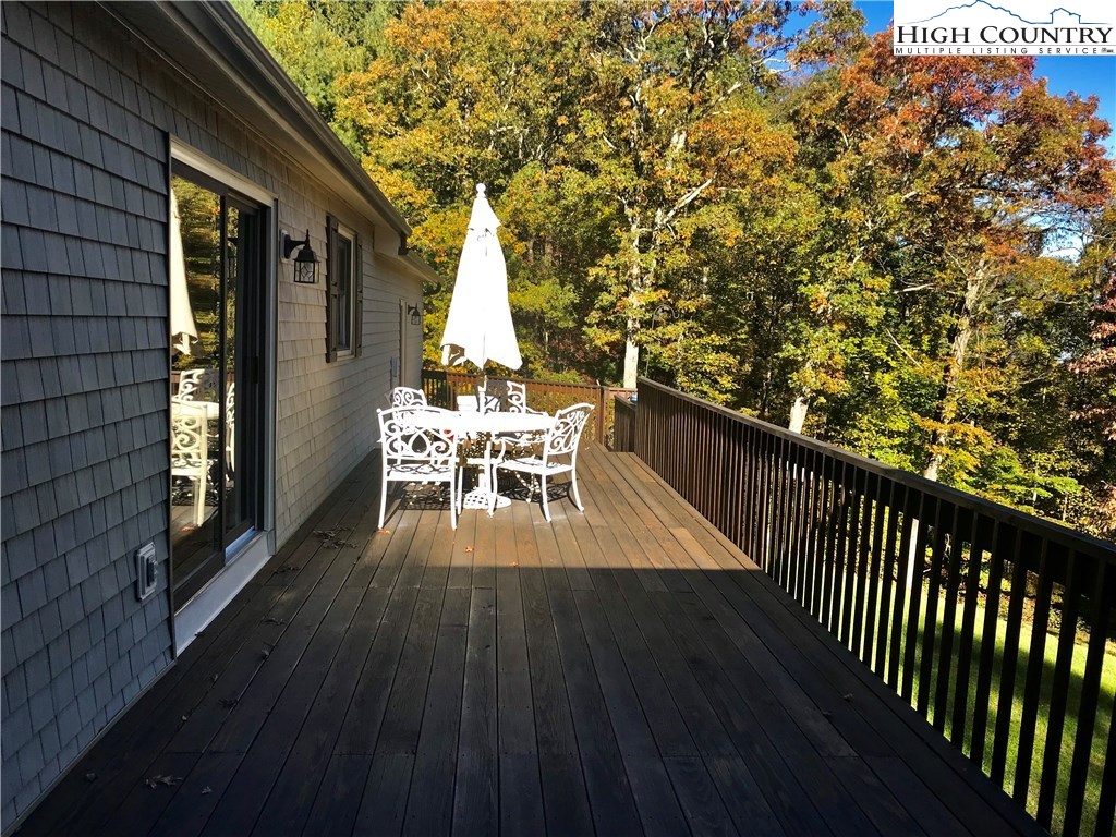 1307 Ben Miller Road Deep Gap, NC 28618 - Photo 20 of 26 a view of balcony with wooden floor and outdoor seating