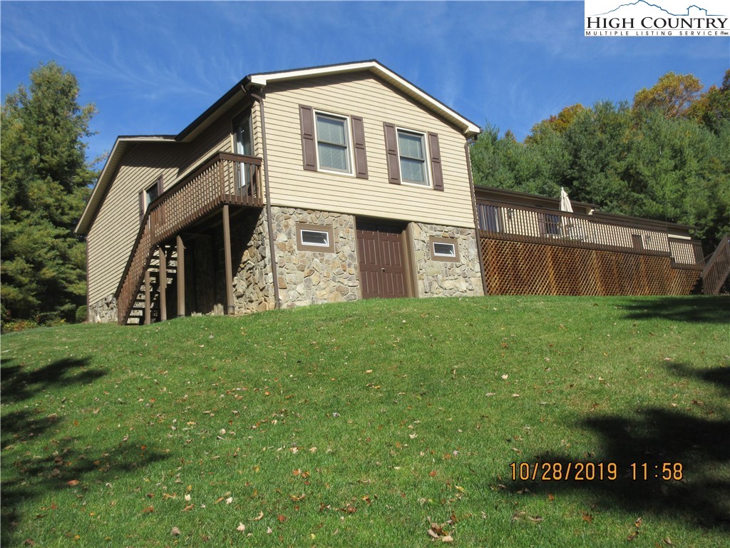 1307 Ben Miller Road Deep Gap, NC 28618 - Photo 24 of 26 a front view of a house with garden