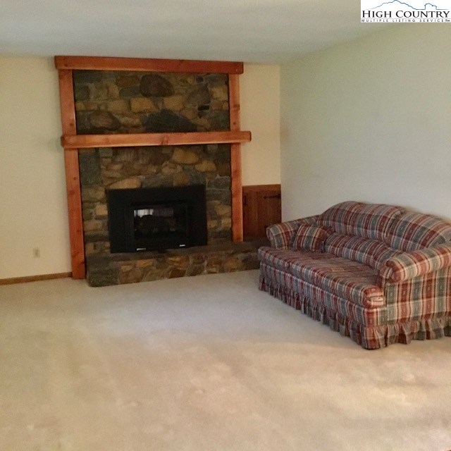 1307 Ben Miller Road Deep Gap, NC 28618 - Photo 7 of 26 a living room with furniture and a fireplace